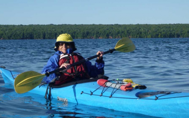adults explore apostle islands by kayak